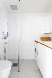 a bathroom with a shower and a toilet and a sink at 2ndhomes Ullanlinna Penthouse Apartments in Helsinki