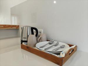 a wooden tray with utensils on a counter at Alam Cottage Uluwatu in Uluwatu