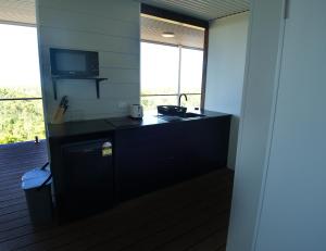 a kitchen with a counter with a sink and two windows at DUENDE Sirène Mermaid in Midgeton