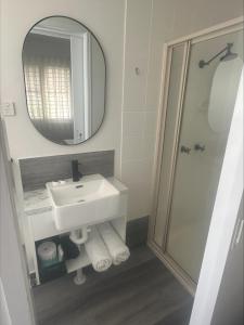 a bathroom with a sink and a mirror at Ellis Beach Oceanfront Holiday Park in Palm Cove