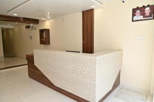 a bathroom with a white counter top in a room at RS GUEST HOUSE in Nagpur