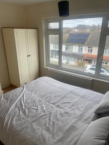 a bedroom with a white bed and a window at ODF foundation apartments in Strood