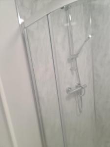 a glass shower door with a pair of scissors at ODF foundation apartments in Strood