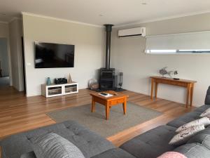 a living room with a couch and a tv at Peterborough Getaway in Peterborough