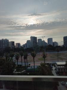 a city skyline with palm trees in a parking lot at Studio Bohemio in Lima