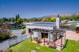an aerial view of a house with a lawn at Sargood Splendour - Wanaka Holiday Home in Wanaka