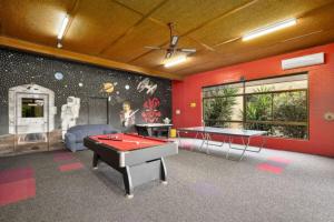 a room with a pool table and ping pong tables at Lakeside Country Club in Numurkah