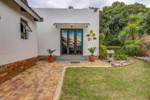 a white house with a front door with plants at Lavender Villa No loadshedding in Kempton Park