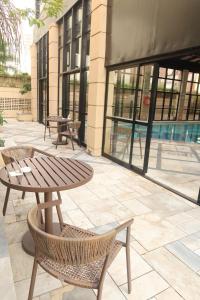 a patio with a table and chairs in front of a building at Lunare Hotel Pinheiros in Sao Paulo