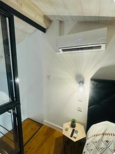 a room with a bed and a small table at Loft cocon climatisé - Imprenable vue sur le château Comtal in Carcassonne
