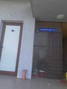 a door to a building with a sign on it at Удобство in Petrich +1 photo