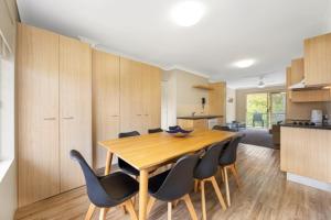a kitchen and dining room with a wooden table and chairs at Tamarind Sands Resort in Cabarita Beach