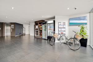 two bikes parked in a room with a store at Comfy Lakeside 1-Bed with Secure Parking in Tuggeranong