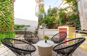 a group of chairs and a table on a patio at Dionysia Sea Side By Greece Apartments in Selianitika
