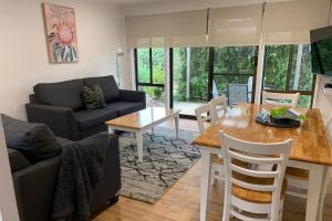 a living room with a table and a couch at The Bright Resort in Bright