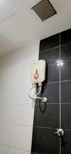 a bathroom with a toilet in the corner of a room at De Viana Apartments Homestay in Kota Bharu