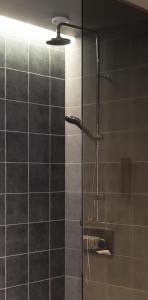 a shower with a glass door in a bathroom at Skuggi Hotel by Keahotels in Reykjavík