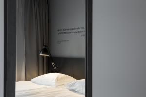 a bedroom with a poster on the wall and a bed at Skuggi Hotel by Keahotels in Reykjavík