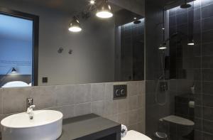 
a bathroom with two sinks and a mirror at Skuggi Hotel by Keahotels in Reykjavík
