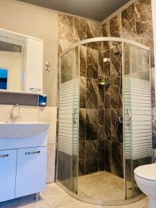 a bathroom with a shower and a sink at Çıralı Marina Loft in Cıralı