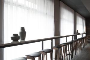 a row of chairs in a room with large windows at Skuggi Hotel by Keahotels in Reykjavík