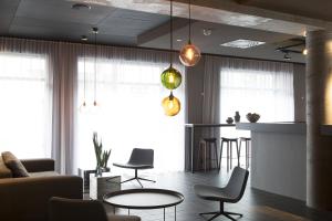 a living room with a table and a bar at Skuggi Hotel by Keahotels in Reykjavík