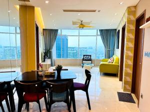 a living room with a table and chairs and a couch at Soho Star Suites near by Klcc in Kuala Lumpur