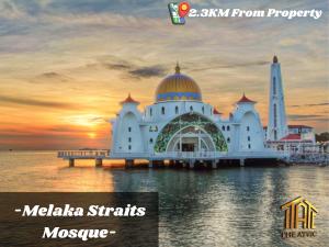 a mosque on the water with the sunset in the background at Attic Home Melaka Silverscape Residence & Jonker in Malacca