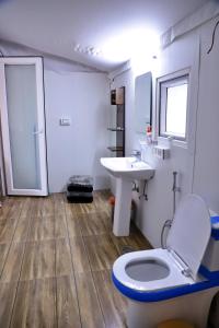 a bathroom with a toilet and a sink at MUSSOORIE ADVENTURE RESORT in Mussoorie