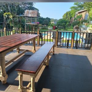 a wooden bench sitting on top of a deck at Wylie Hall Guesthouse in Durban