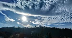 a cloudy sky with the sun in the middle at Pod 20 in Jelenia Góra