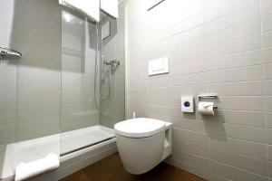 a bathroom with a toilet and a shower at Hotel Schlüssel in Luzern