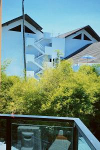 a view of a building from the balcony of a house at Sasimanta in Kamala Beach