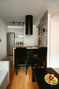 a kitchen with a table and chairs in a room at Apartment by the River II in Szczecin