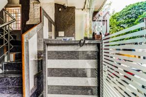 a lobby with a wall of colorful tiles at Solar Inn in Tirupati