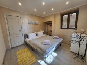 een slaapkamer met een bed met twee handdoeken erop bij Guest house Dimant in Boergas
