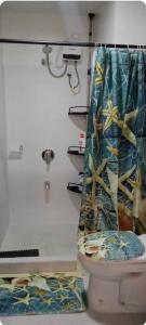 a bathroom with a toilet with a shower curtain at Cebu 1 bed Luxury Condo with high speed Internet in Cebu City