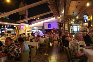 a group of people sitting in a restaurant at MiTOS APART OTEL in Alanya