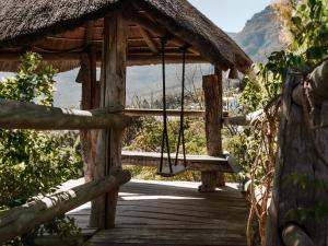 a wooden bridge with a swing in the mountains at Wonderland in Hout Bay