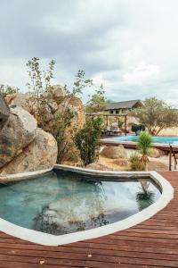 a swimming pool in the middle of a wooden deck at Ohorongo Tented Camp in Kaneb Pos