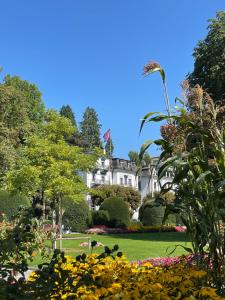 a view of the white house from the gardens at Hotel Schlüssel in Lucerne
