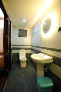 a bathroom with a sink and a toilet at IndraprasthamLakeCruise in Alleppey