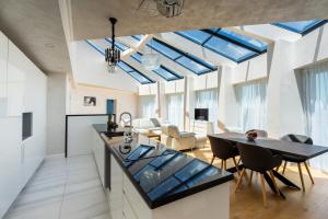 a kitchen with skylights and a dining room at The LODGE Summer Apartments Sozopol in Sozopol
