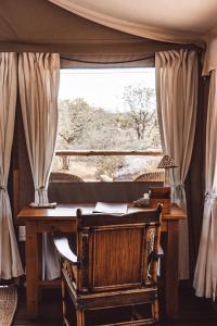 a desk in a room with a window at Ohorongo Tented Camp in Kaneb Pos