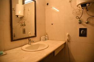 a bathroom with a sink and a mirror at Himtrek Stays Delhi in New Delhi