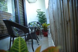 a balcony with chairs and potted plants on it at Himtrek Stays Delhi in New Delhi