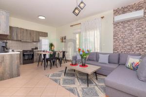 a living room and kitchen with a couch and a table at Four Seasons - Spring in Alexandroupoli
