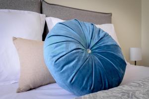 a blue pillow sitting on top of a bed at Four Seasons - Spring in Alexandroupoli