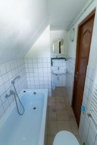 a bathroom with a tub and a toilet and a sink at House Jakob Camping Ananas Cisnadioara in Cisnădioara