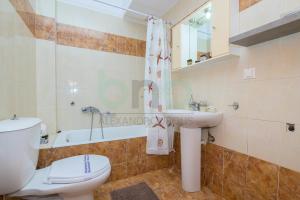 a bathroom with a toilet and a sink and a tub at Four Seasons - Spring in Alexandroupoli
